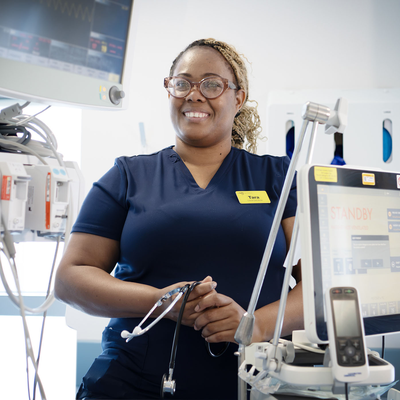 Tara Walters in a medical setting surrounded by medical equipment and screens