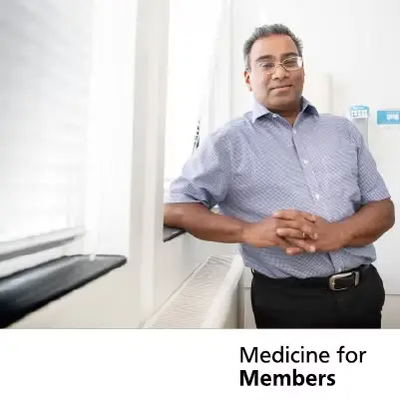 Professor Vincent Gnanapragasam leaning against a window in a hospital. Text below reads 'Medicine for Members'