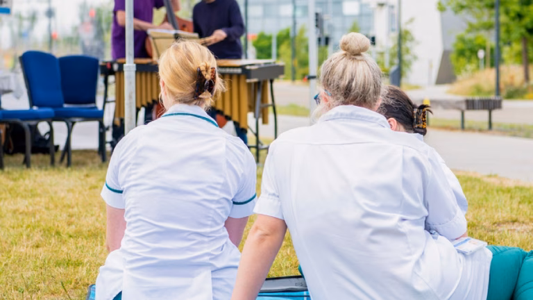 NHS Staff listen to music outside.