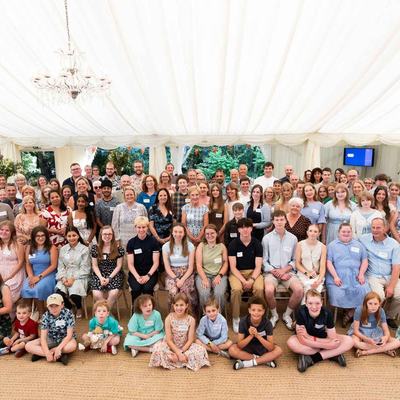A large group of happy people in a beautiful marquee
