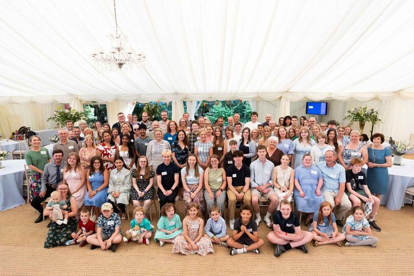 A large group of happy people in a beautiful marquee