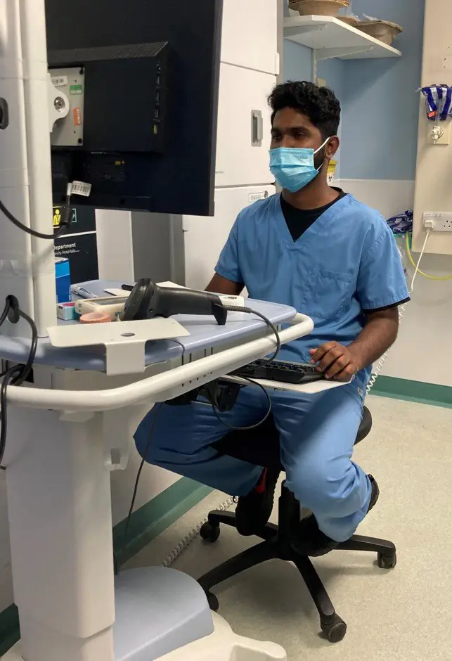 Emergency Department triage nurse using a workstation computer.