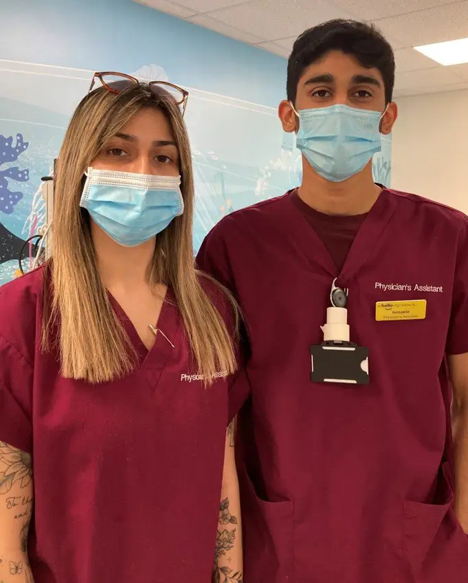Two Emergency Department Physicians Assistant's wearing maroon scrubs.