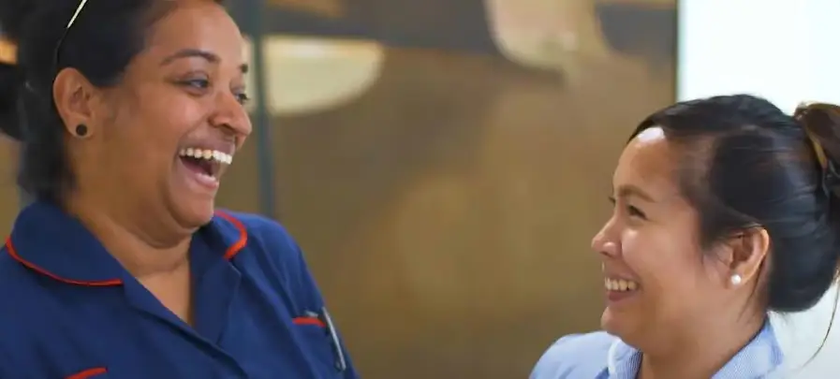 Two colleagues smiling at each other