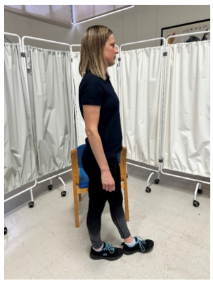 A woman standing with her left foot in front of her right foot