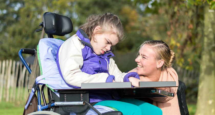 A photo of a young girl and her carer