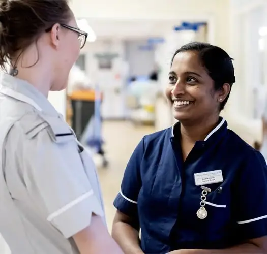 Nurses smiling on a hospital ward