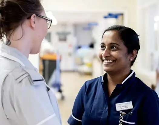 Nurses smiling on a hospital ward