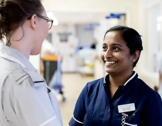 Nurses smiling on a hospital ward
