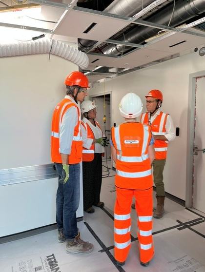 CCH Team members standing in the Moorfields Eye Hospital, which is currently under construction- all are wearing PPE, hardhats and high vis vests.