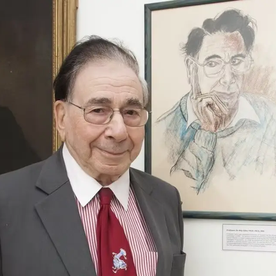Sir Roy Calne standing next to a portrait of himself