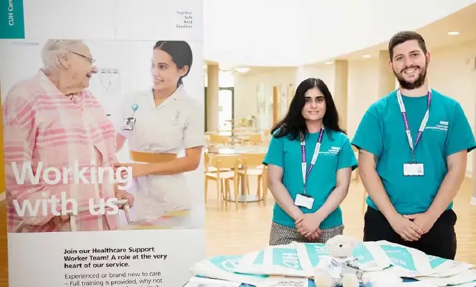 Staff giving away free items at recruitment event