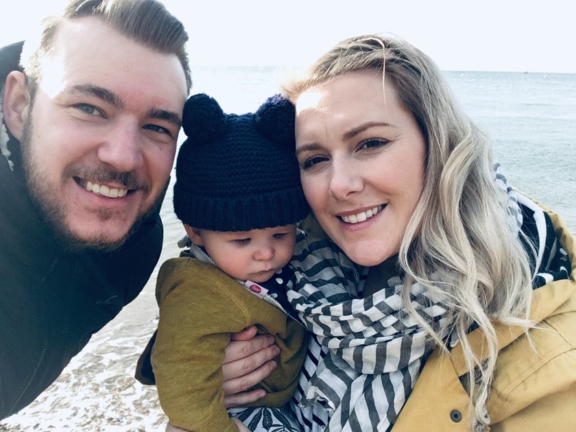 Family photo by the sea, dad Nathan, baby Reuben and mum Danielle