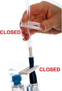 Close-up of a hand holding medical tubing with a clamp, showing the clamp in the closed position above a suction canister; “CLOSED” is labeled on the image.