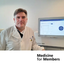 Patrick Tarpey in a white lab coat standing by a screen. Text reads 'Medicine for Members'